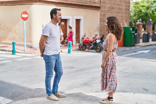 Man and woman couple smiling confident standing together at street