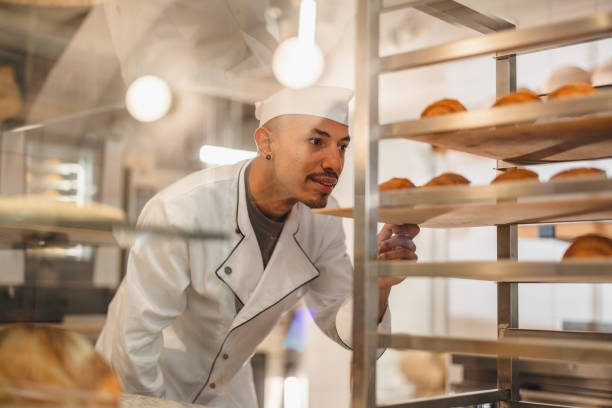 istock Baker Looking At Freshly Made And Delicious Croissants In His Bakery 1436415081