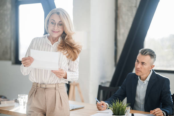istock A blonde elegant woman in the offcie with documents in hands 1436415110