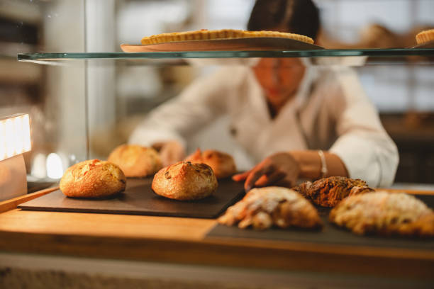 istock Baker Arranging Pastry In The Shop 1436415504