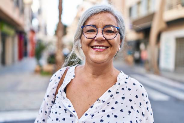 istock Middle age woman smiling confident standing at street 1436415781