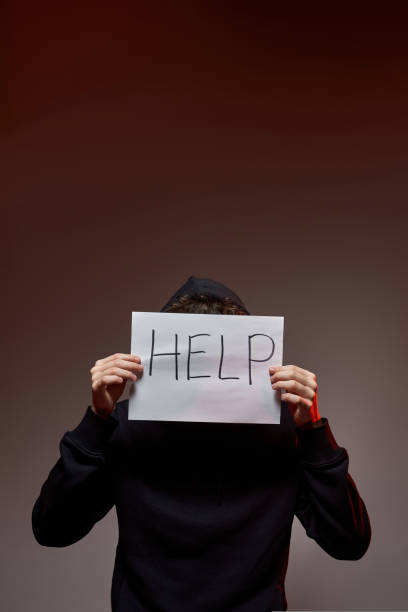 istock Guy covering his face white paper with word 'help' 1436418031