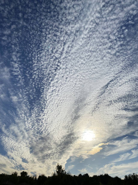 istock Sky covered by Altocumulus floccus clouds on sea with island 1436418082