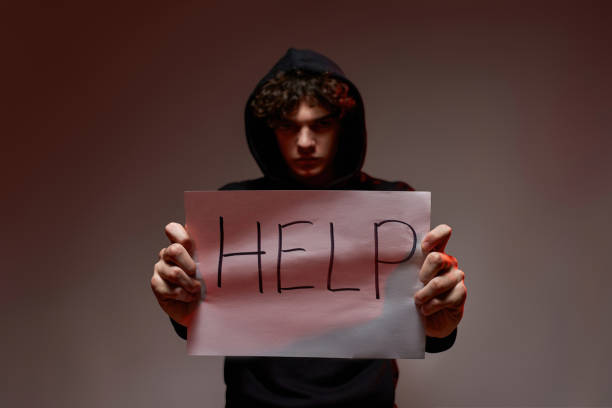 istock Front of confident guy hold paper with word 'help' 1436418254