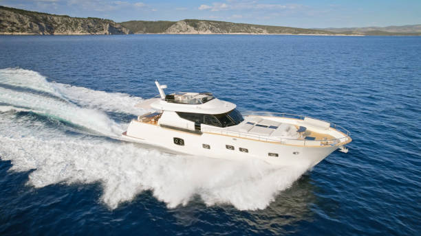 Aerial view of luxury yacht cruising in sea during sunny day.