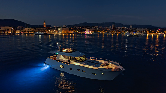 Aerial view of luxury yacht moored in Adriatic sea against city, Split, Croatia.