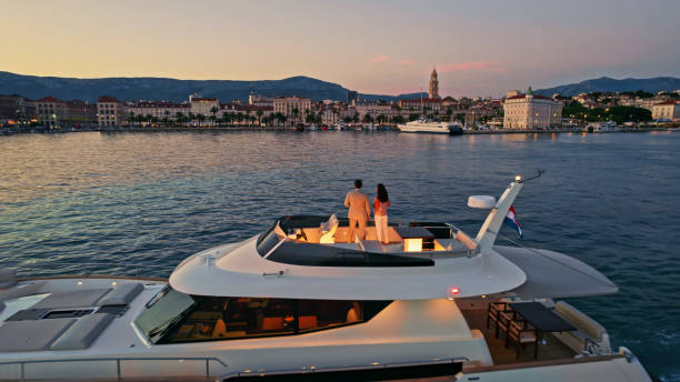 Couple standing on yacht Couple standing on luxury yacht in Adriatic sea against city, Split, Croatia. Croatia stock pictures, royalty-free photos & images