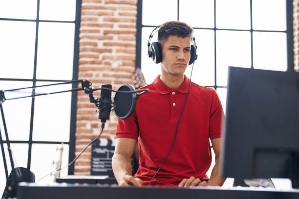 istock Young hispanic man musician playing piano with relaxed expression at music studio 1436421665