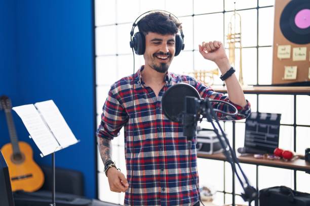 istock Young hispanic man artist singing song at music studio 1436422371