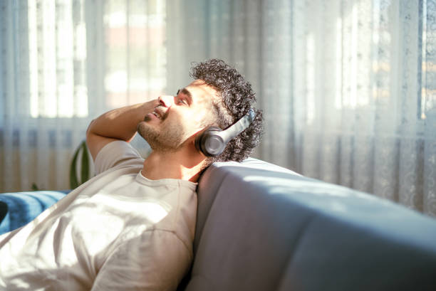 istock Young man with eyes closed, enjoying music. calming down 1436422911