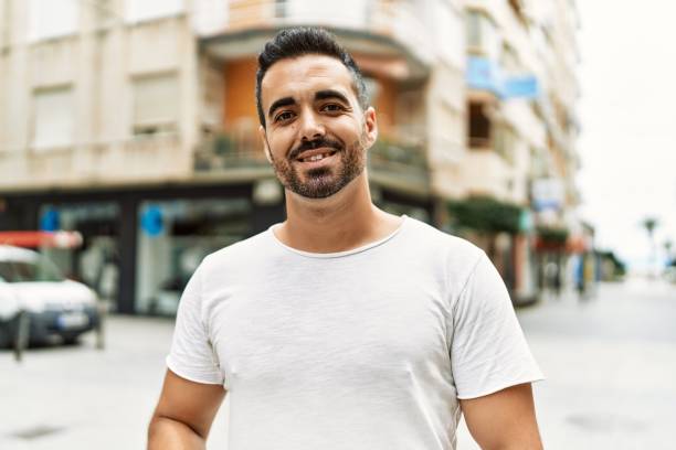 istock Young hispanic man smiling confident walking at street 1436423515
