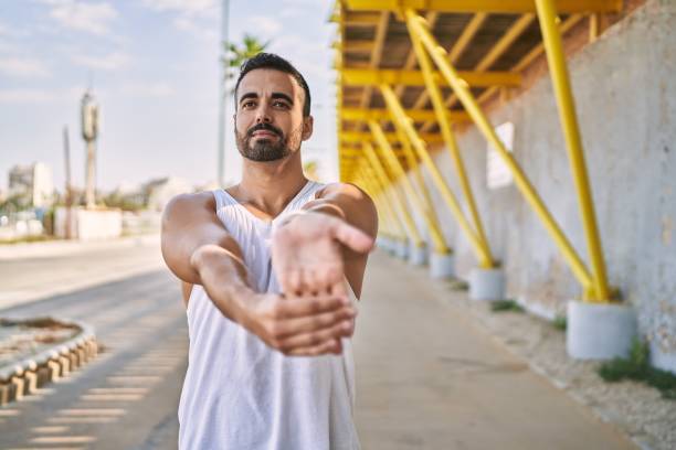 istock Hispanic man stretching after working out outdoors on a sunny day 1436423593