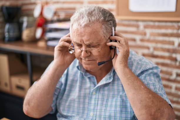 istock Middle age grey-haired man call center agent working at office 1436424086