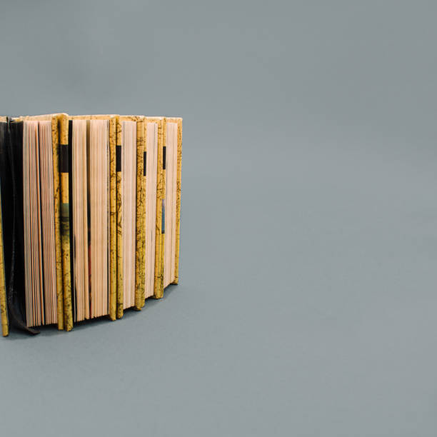 istock Book collection on gray background with copy space. Minimal library concept. Paper ready to be read. New novel idea. 1436424379