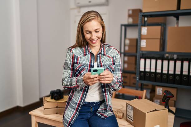 istock Young blonde woman ecommerce business worker using smartphone at office 1436426904