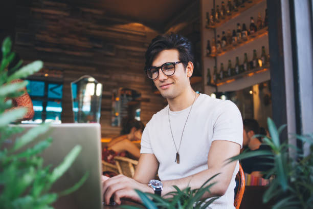 istock Cool man in eyeglasses working on laptop with pleasure 1436426968