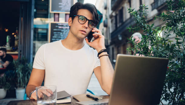 istock Young smart man speaking on smartphone at cafe in Barcelona city 1436426982