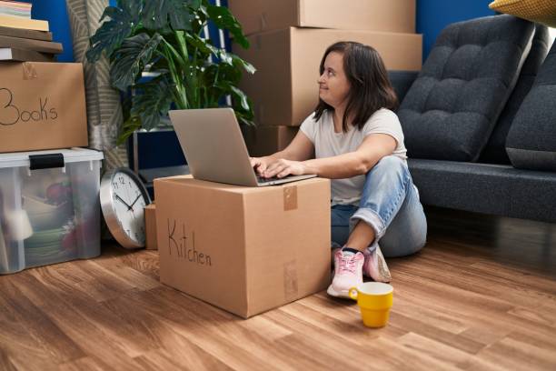 istock Down syndrome woman smiling confident using laptop at new home 1436428426