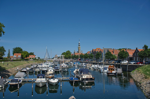 VEERE, NETHERLANDS - The marina (harbor) and historic buildings with the clock tower of the Stadhuis (town hall) in Veere, Zeeland