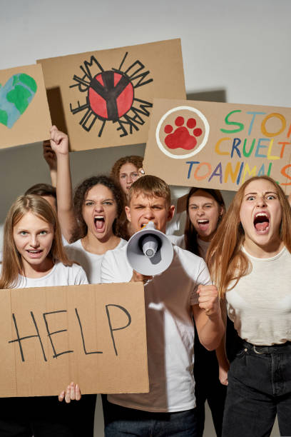 istock Irritated teenagers with placards protest on rally 1436430886