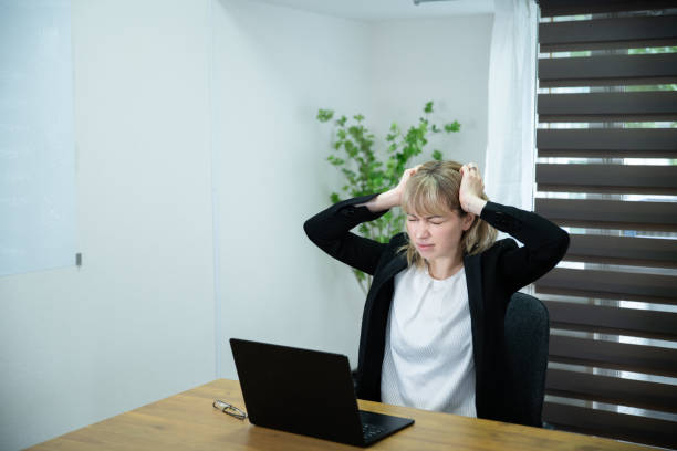 istock An office worker lady stressed at the desk 1436431374
