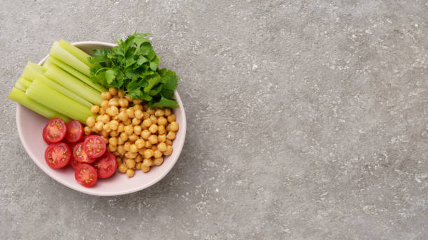 plate with various raw vegetables and boiled chickpeas