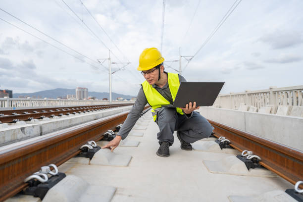 istock A Chinese male engineer works on a tablet computer at a railway construction site under construction. 1436440385