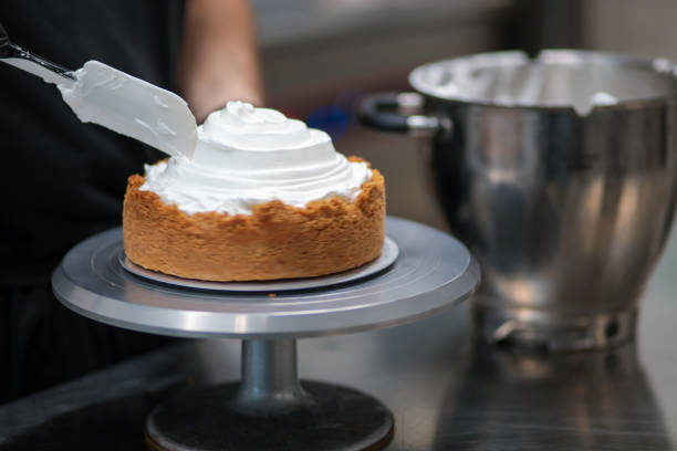 istock pastry chef designer filling a pie crust with lemon flavour meringue mousse cheese cream with spatula 1436440821