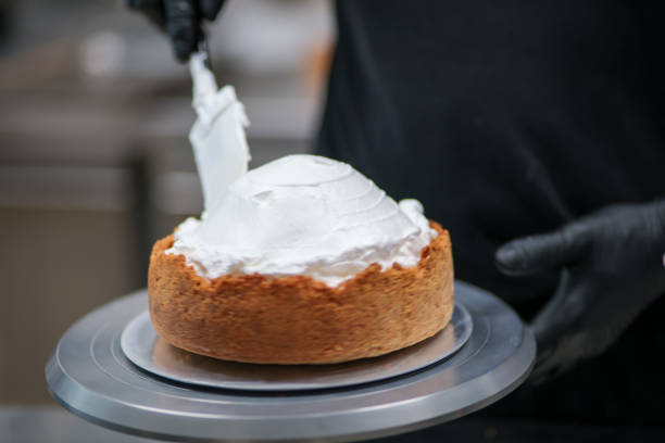 istock pastry chef designer filling a pie crust with lime flavour meringue with spatula 1436440850