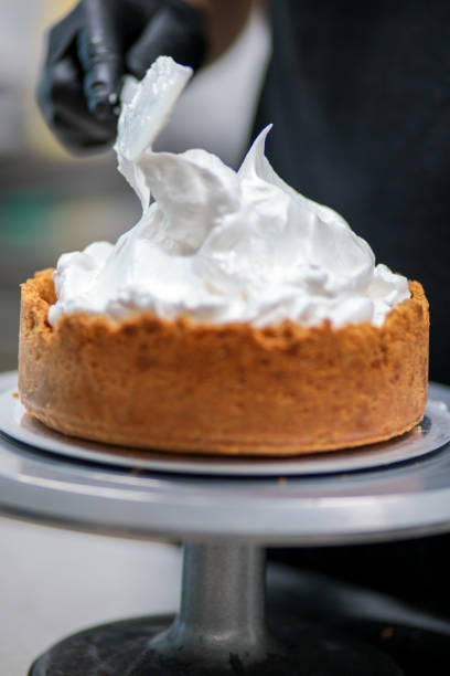 istock pastry chef designer filling a pie crust with lime flavour meringue with spatula 1436440869
