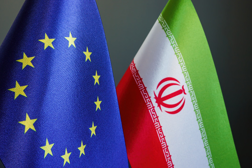 Flags of the EU and Iran as symbol of negotiations.