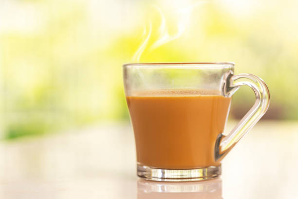 Cup of tea with steam on table