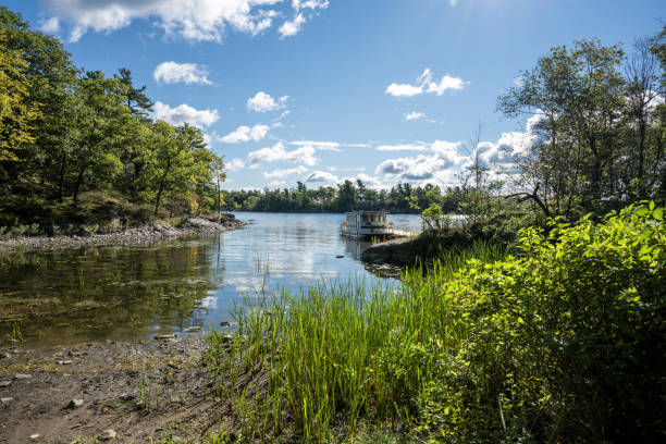 istock Waterfront summer scene with a houseboat 1436442340
