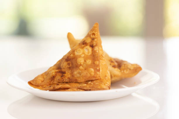 Plate of hot Samosas on table in studio light.
