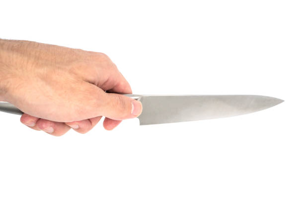 istock Hand holding a sharp gray knife isolated on white background. Kitchen knife 1436443798