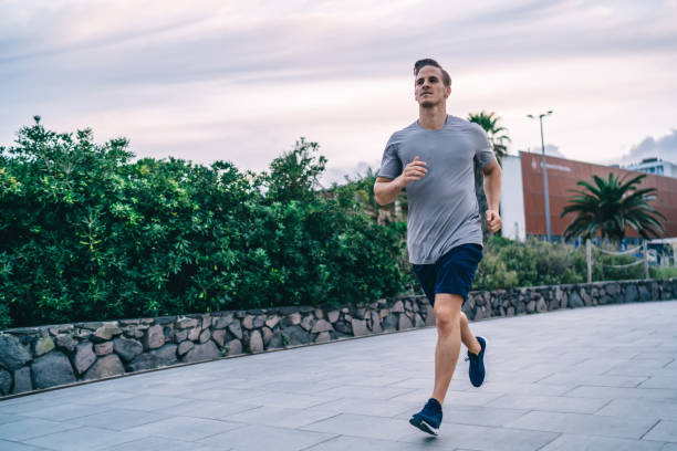 istock Handsome determined active male jogger enjoying energy and power during cardio training keeping healthy lifestyle,20s strong caucasian man with muscular strong body running on workout on city 1436444721