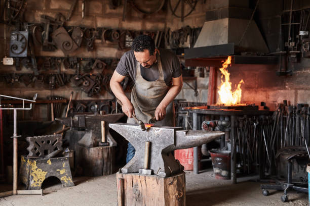 Blacksmith workshop, industry professional in metal and steel production foundry. Anvil, grip hammer and worker using vintage forging process tools in industrial manufacturing or storage studio taller de herrería, profesional de la industria en fundición de producción de metales y aceros. yunque, martillo de agarre y trabajador que utiliza herramientas de proceso de forja vintage en la fabricación industrial o estudio de almacenamiento