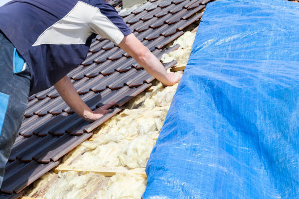 istock a roofer laying tile on the roof 1436445636