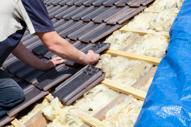 istock a roofer laying tile on the roof 1436445637