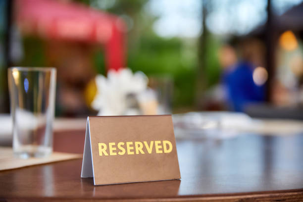 istock Plastic plaque with the inscription Reserved on the restaurant table. 1436445871