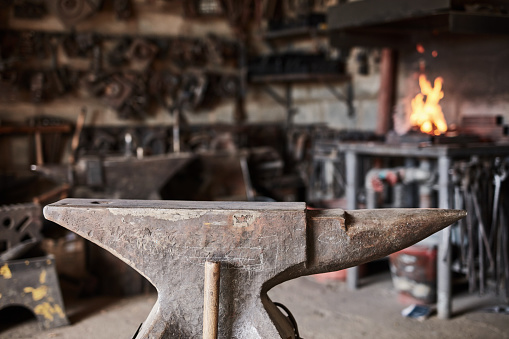 Old smithy with fire before starting work. Working environment with tools in a blacksmith workshop