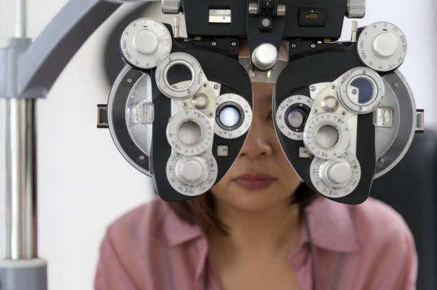 istock Young woman checking her eyesight and choosing glasses 1436447525