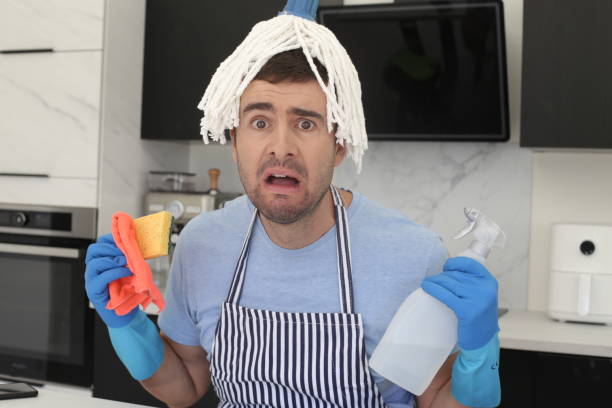 Man trying to clean the kitchen stock photo
