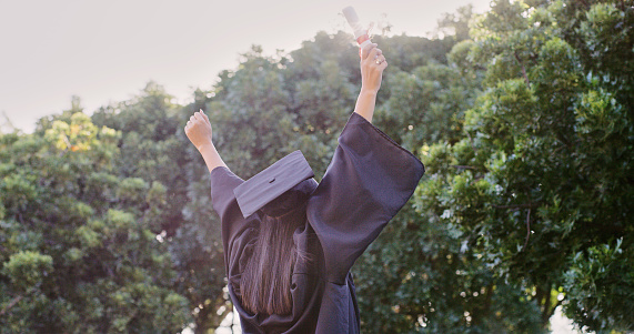Woman, hands up or success graduation certificate on school, university or London college campus. Student, celebration or graduate diploma goals in education, learning scholarship or study motivation