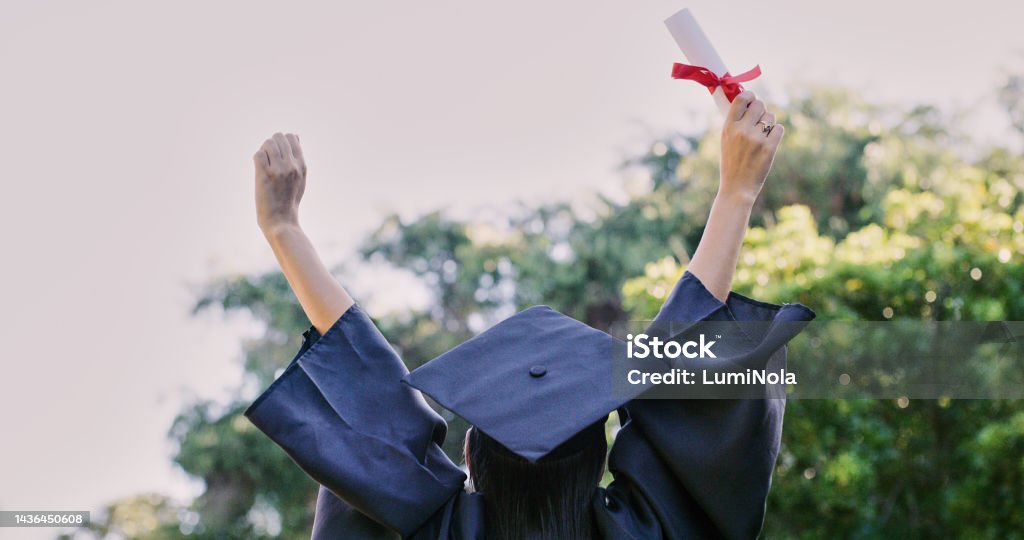 Graduation, education and success with a woman student holding a diploma or certificate in celebration outdoor. University, graduate and study with a female pupil cheering a college achievement Scholarship Stock Photo