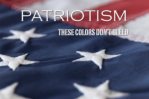 Patriotism - These Colors Don't Bleed framed against an American Flag.