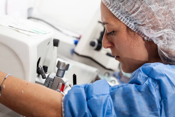 istock Young female scientist works on a rotary microtome to obtain sections from a paraffin-embedded specimen. 1436452059