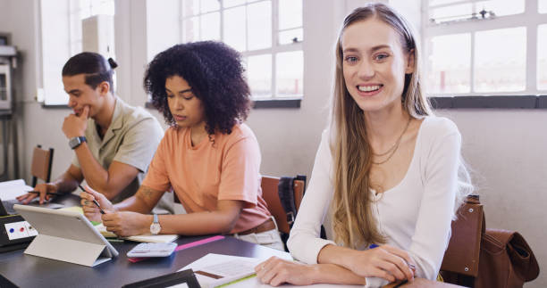 istock Education, studying and accounting students in a classroom with a calculator for finance and learning budgeting. Financial, school and university girl studying, working and bookkeeping in college 1436456502