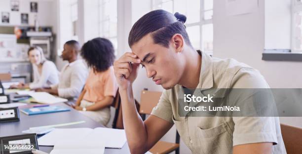 Stress Fail And Education With A Man Student Writing An Exam With Learning Difficulty In A University Classroom Study Scholarship And College With A Young Male Pupil Feeling Burnout In Class Stock Photo - Download Image Now