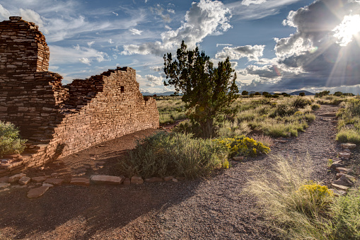 Box Canyon pueblo ruin in Wupatki National Monument near Flagstaff Arizona with sunburst.